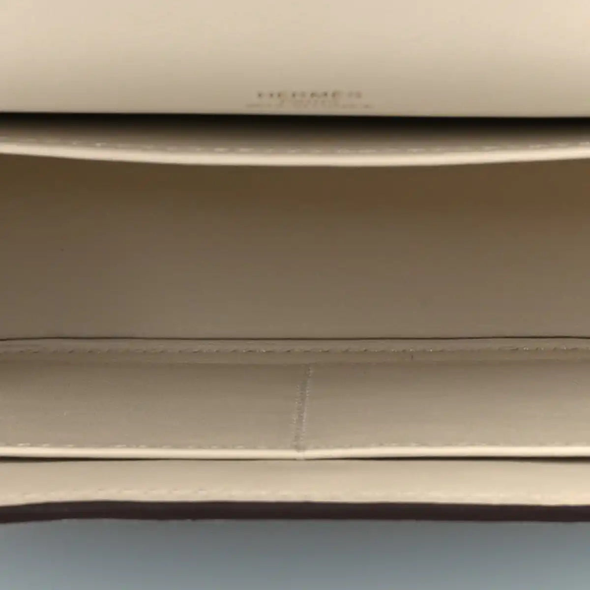 Light leather crossbody lining seam and stitching detail