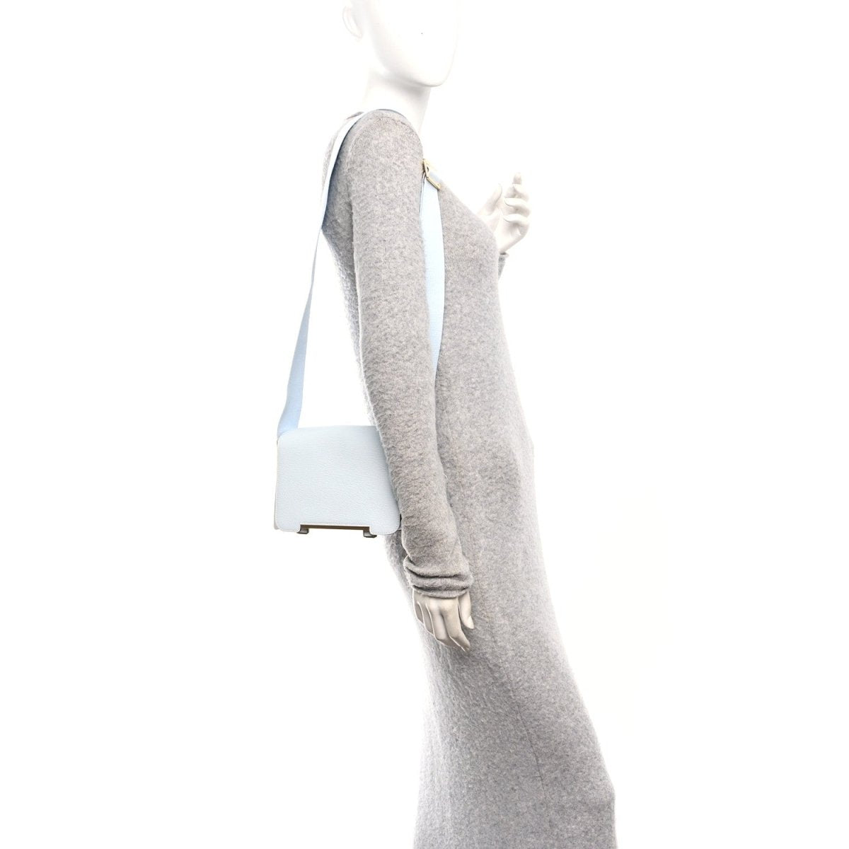 Light blue leather crossbody strap with grey underside and metal hardware