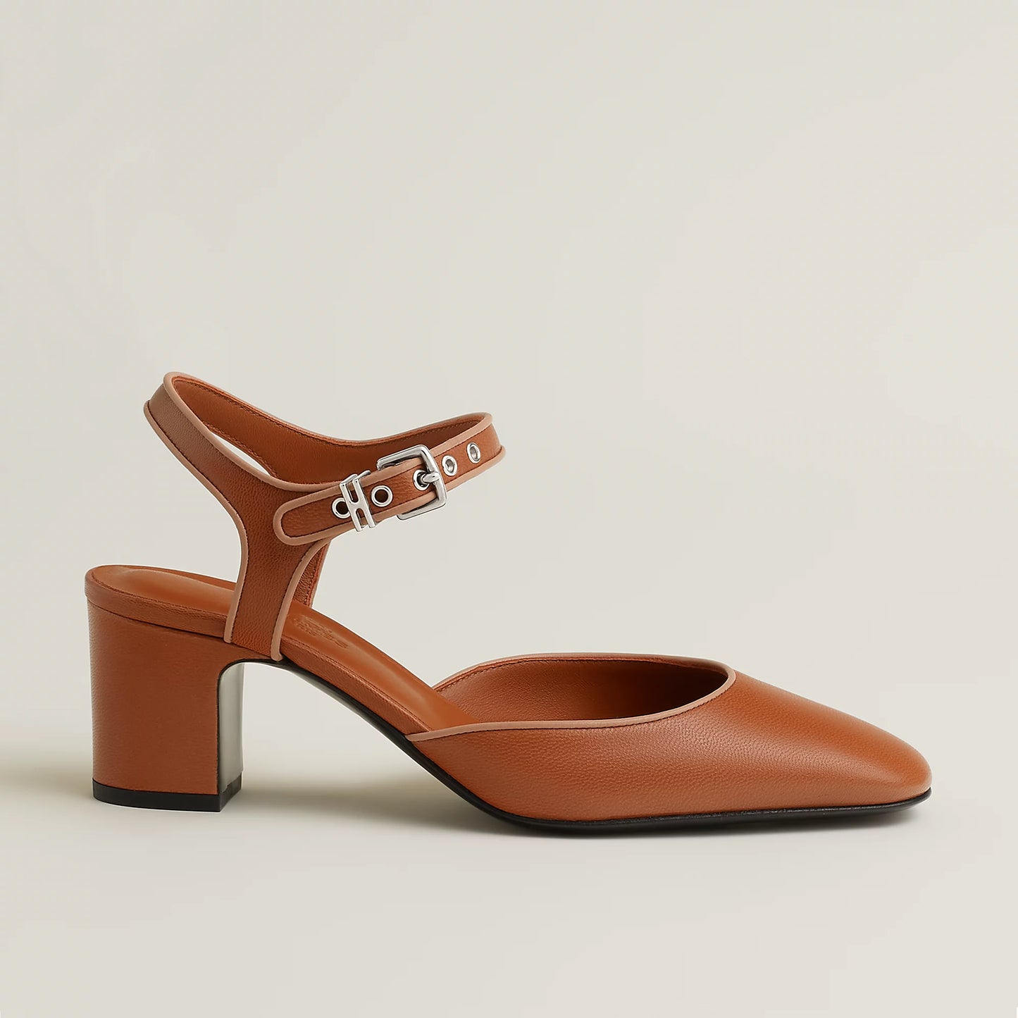 Brown Mary Jane pump with ankle strap and silver buckle, block heel, pointed toe.