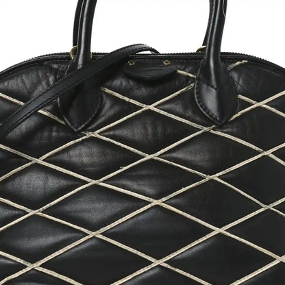Black quilted lattice lambskin handbag with curved top handles