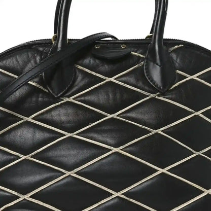 Black quilted lattice lambskin handbag with curved top handles