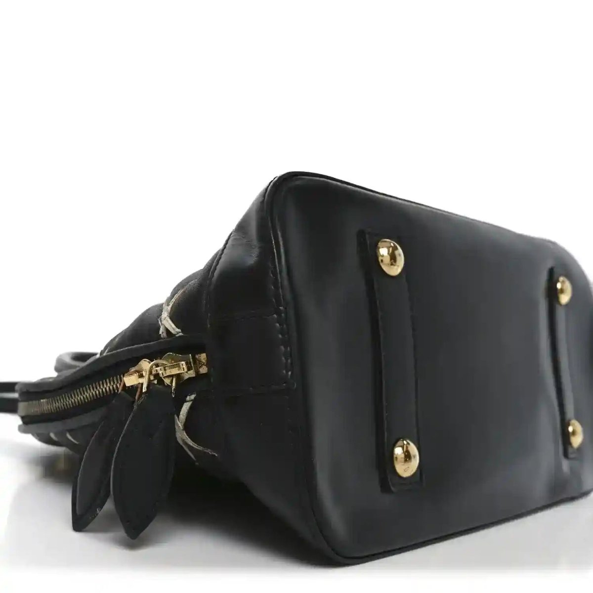 Black leather handbag side view with gold-tone studs and short strap