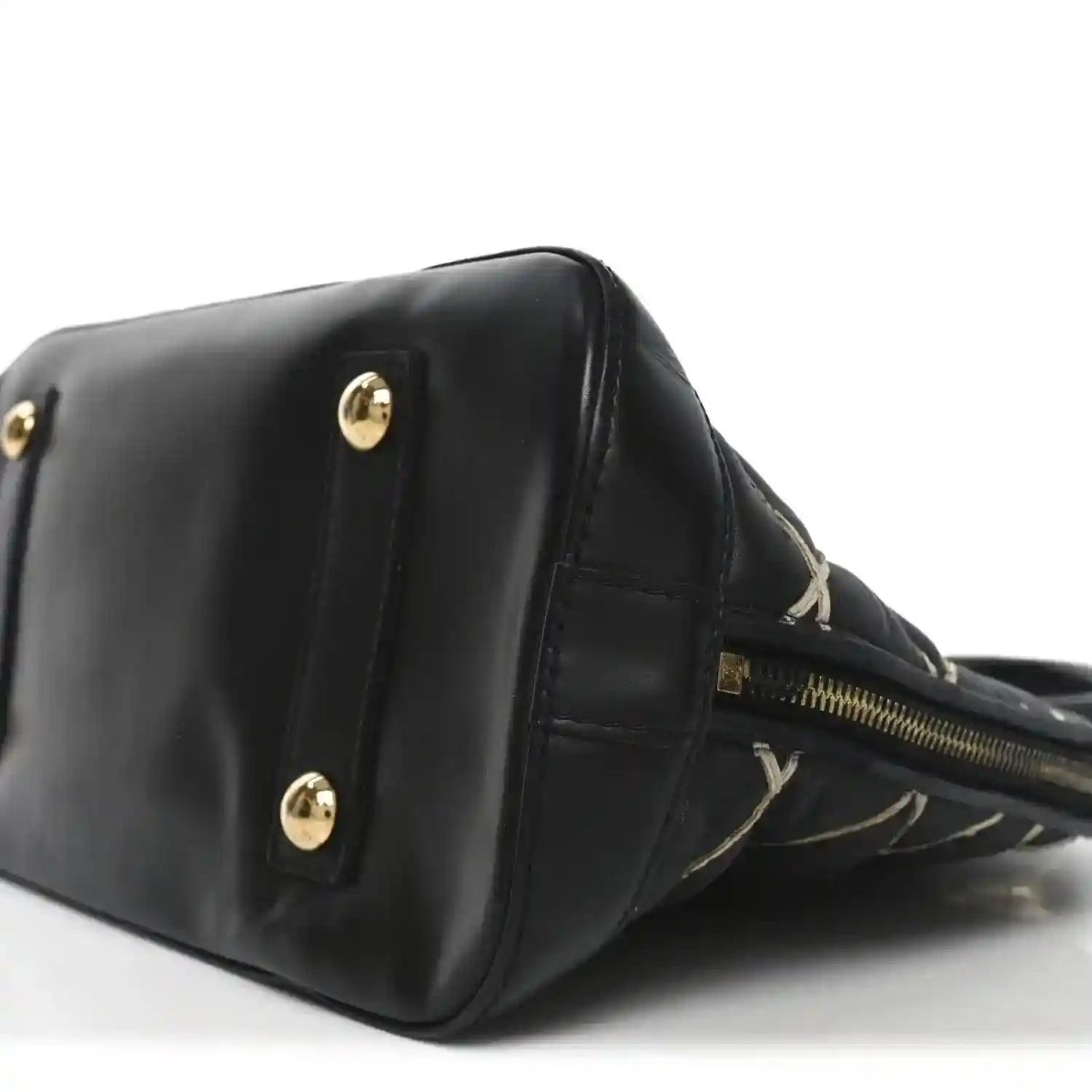 Black handbag corner with gold-tone studs and top zipper