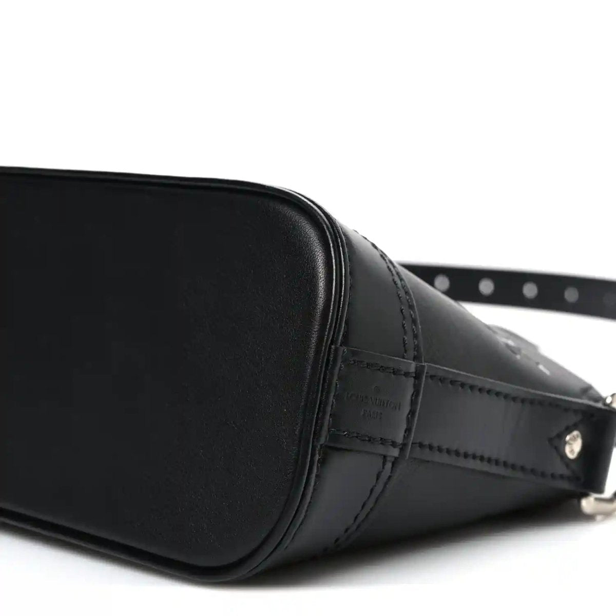 Black Louis Vuitton Alma monogram handbag side view with metal buckle and stitching