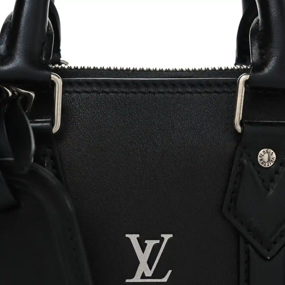 Black Louis Vuitton Alma monogram handbag detail with LV emblem and metal strap loops