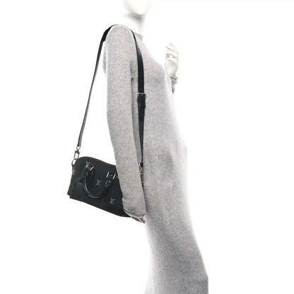 Black Louis Vuitton Alma monogram handbag with short shoulder strap, side profile