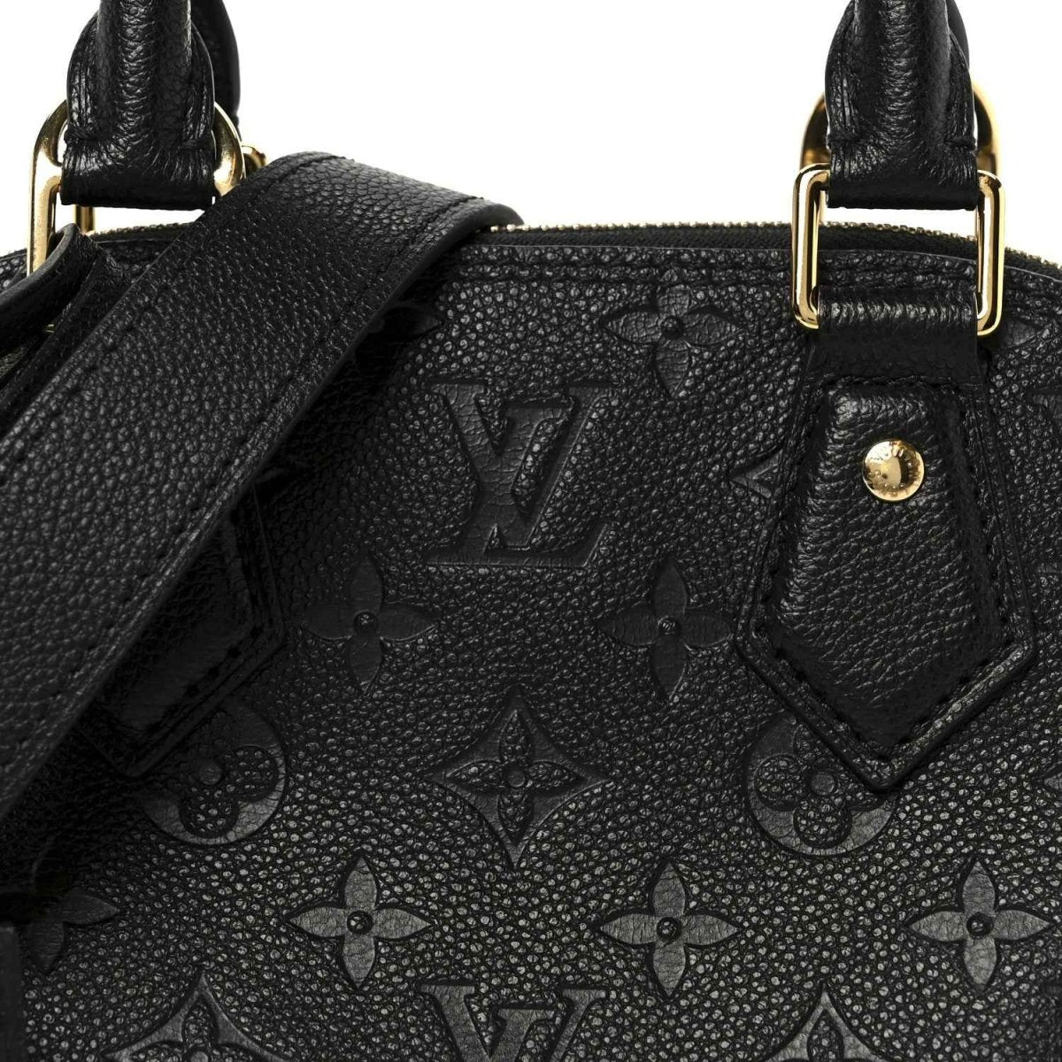 Black embossed monogram leather panel with stitched edges near handle