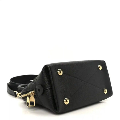 Black leather handbag with gold-tone feet, short strap, and top handle