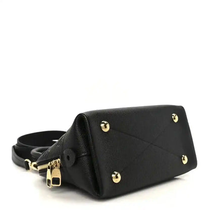 Black leather handbag with gold-tone feet, short strap, and top handle