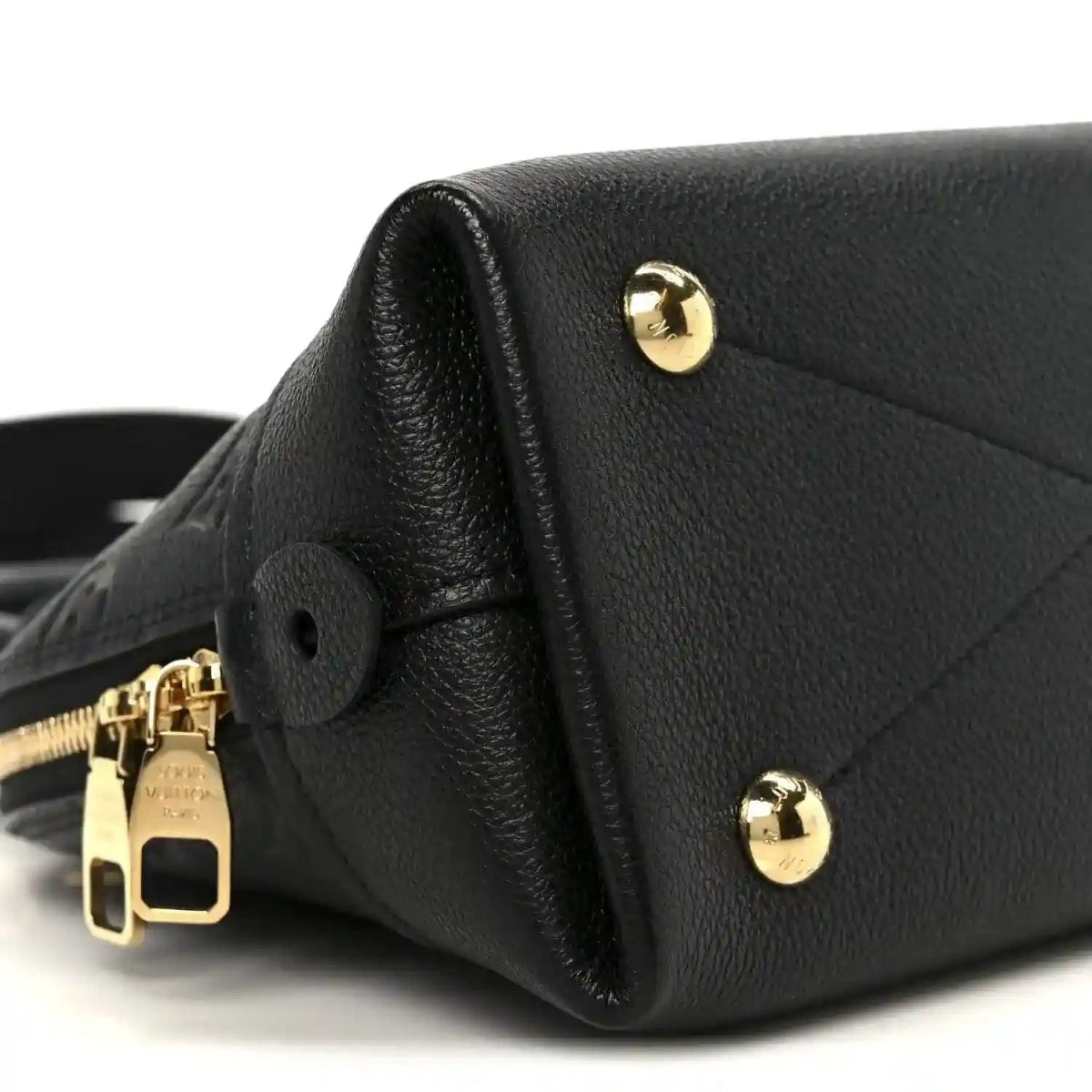 Black leather handbag with gold-tone hardware and circular leather tab