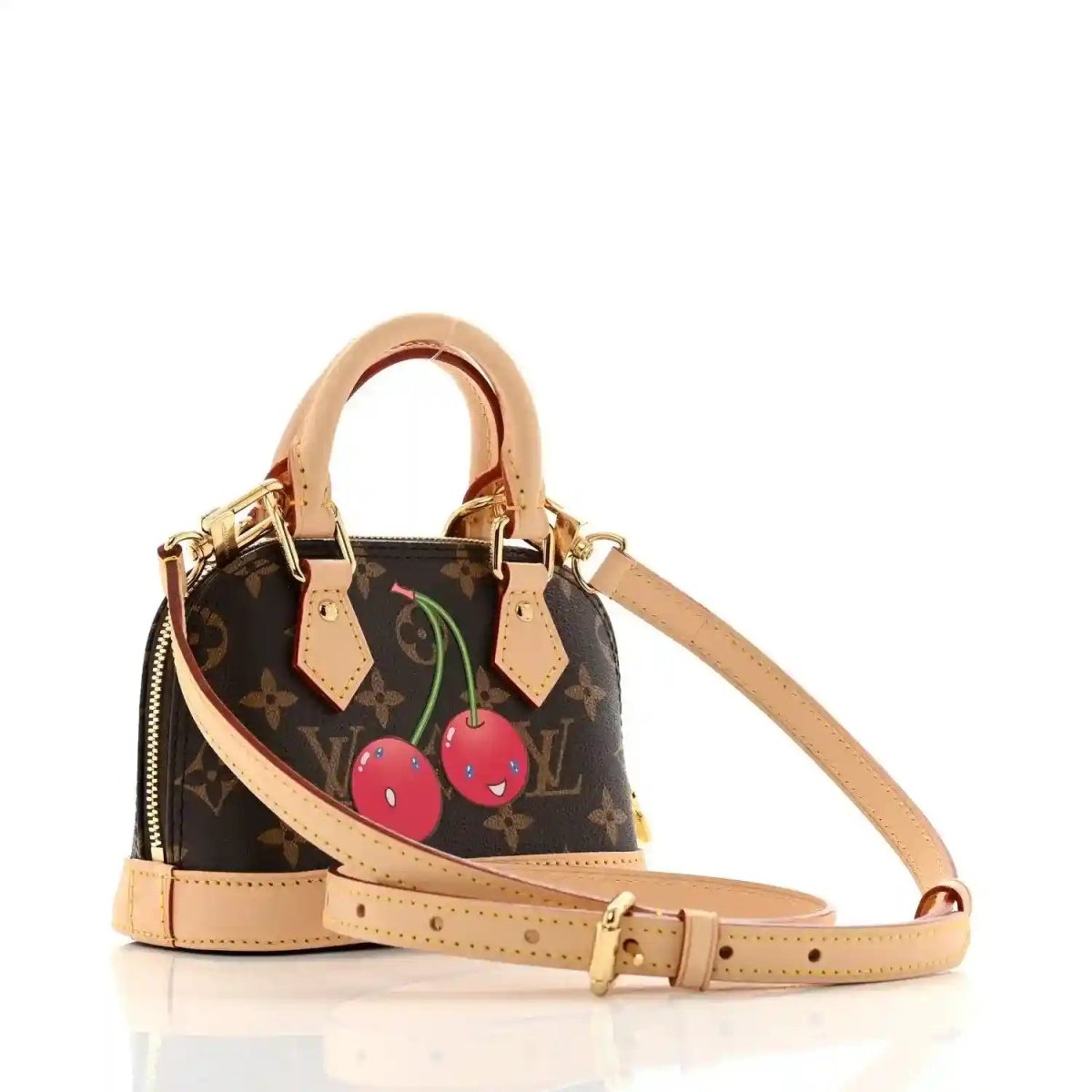 Mini tote handbag with tan handles, dark monogram canvas, cherry appliqué and strap
