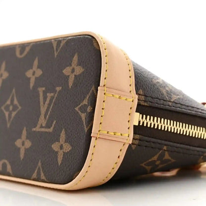 Mini crossbody bag with dark monogram canvas, tan side trim, gold zipper