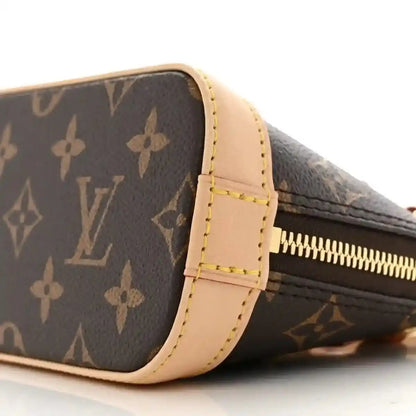 Mini crossbody bag with dark monogram canvas, tan side trim, gold zipper