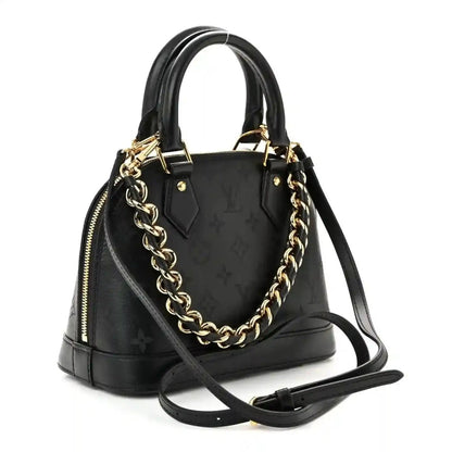 Louis Vuitton Alma BB handbag, black embossed monogram leather with gold chain strap