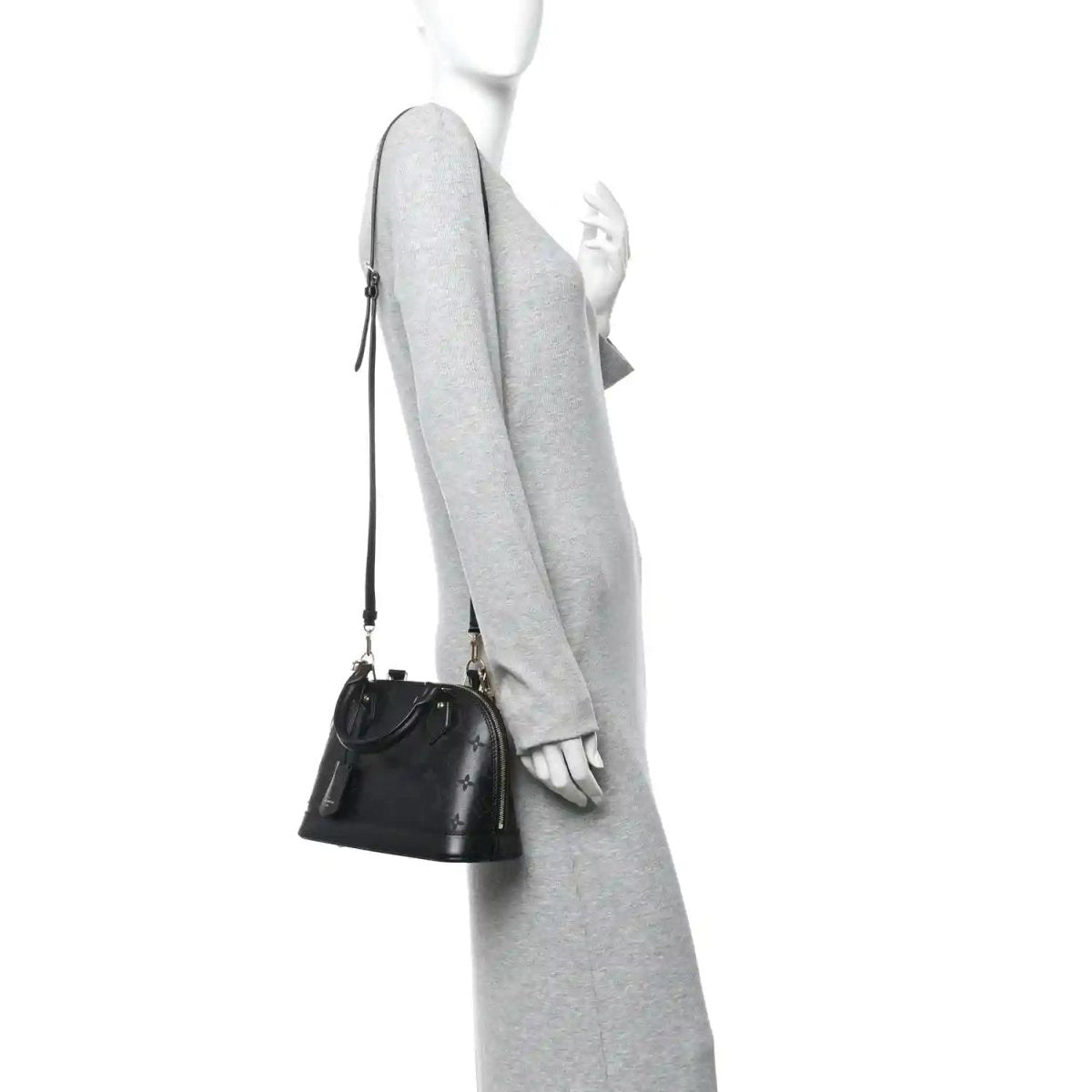 Louis Vuitton Alma BB handbag on model, black embossed leather with slim shoulder strap