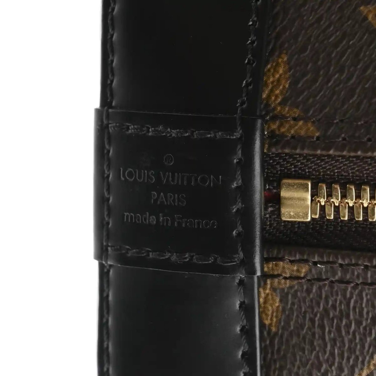 Small monogram tote close-up of black leather patch with Louis Vuitton Paris text