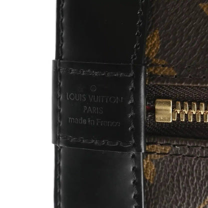 Small monogram tote close-up of black leather patch with Louis Vuitton Paris text
