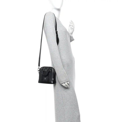 Louis Vuitton Nano Alma mini tote crossbody view in black calfskin with shoulder strap
