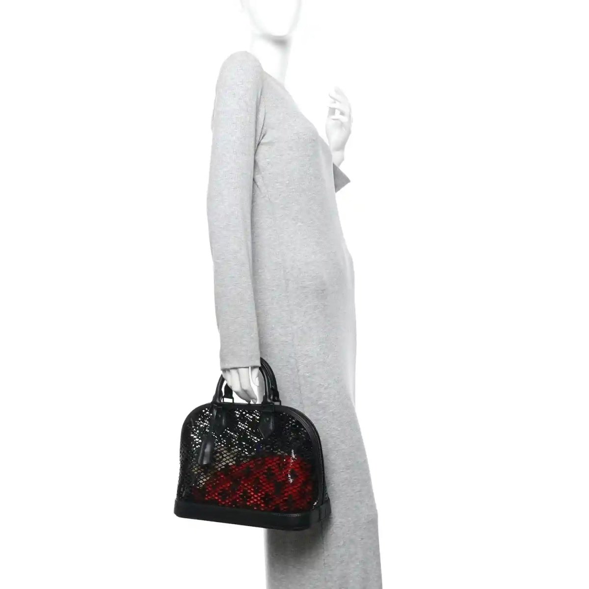 Black patent laced monogram Alma PM handbag side view on a person