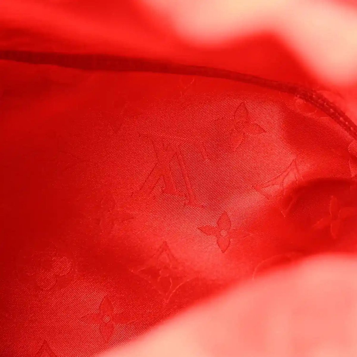 Red monogram fabric lining with zipper seam and curved edge