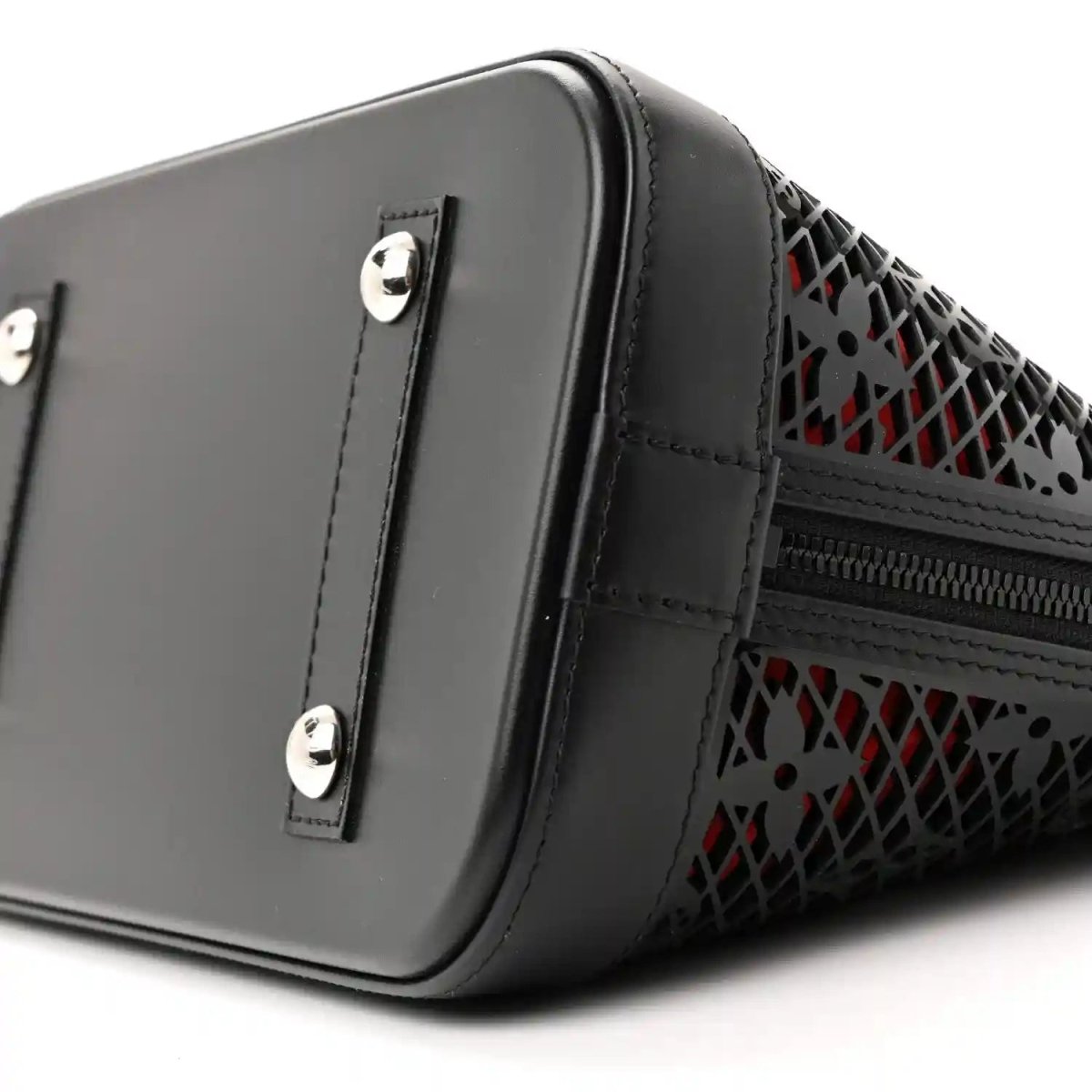 Black patent leather handbag with silver hardware, monogram laced trim, and side zipper