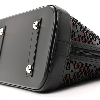 Black patent leather handbag with silver hardware, monogram laced trim, and side zipper
