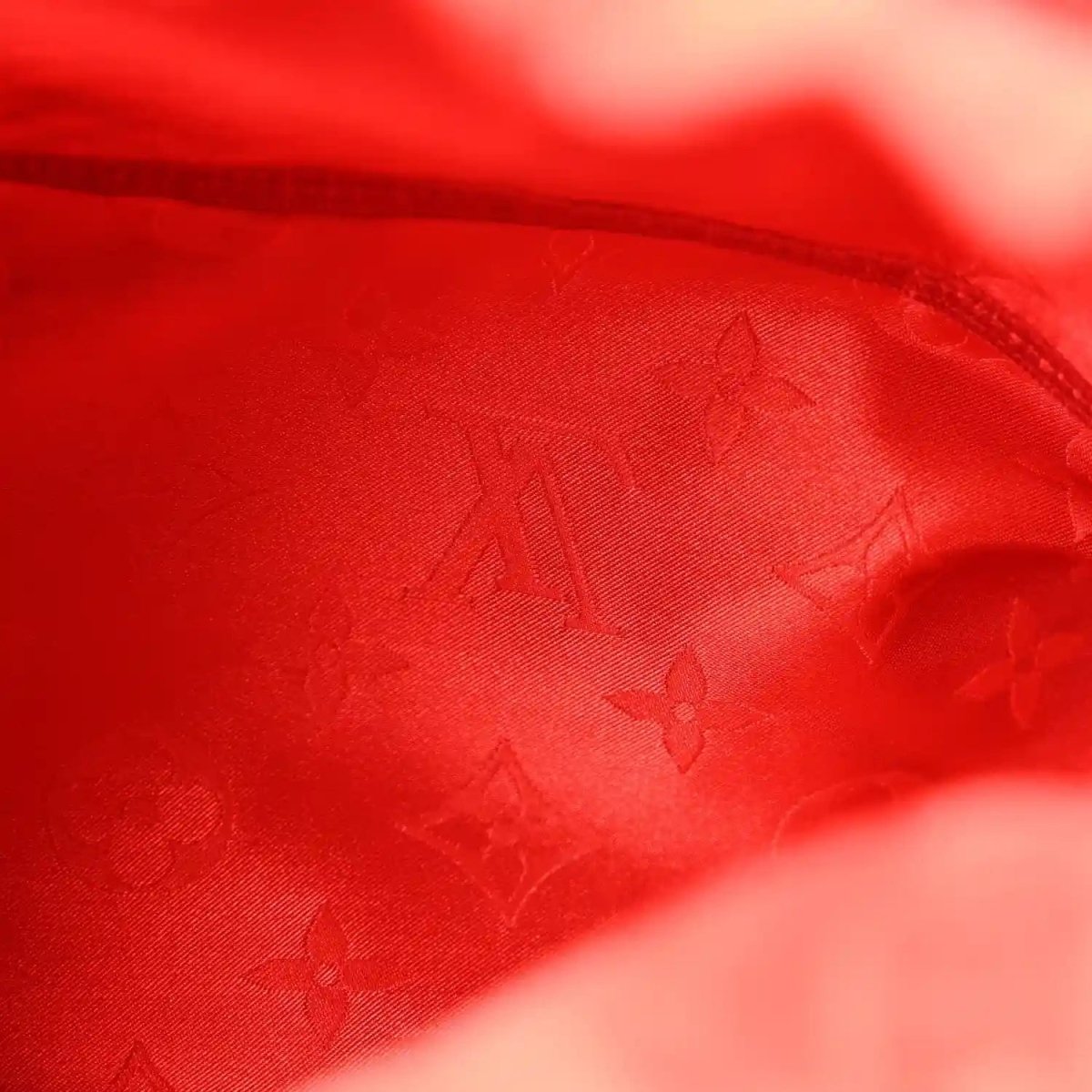 Red interior lining with monogram pattern, close-up textile texture