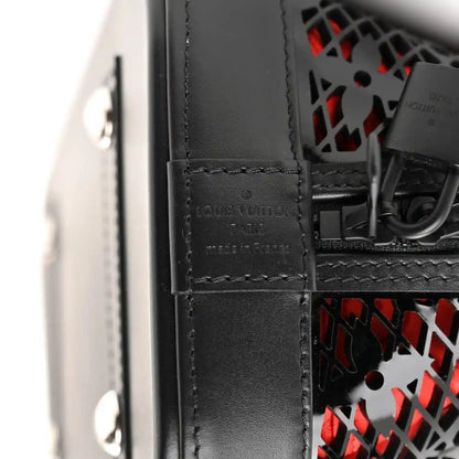 Black leather handbag strap attachment with Louis Vuitton logo, stitched close-up