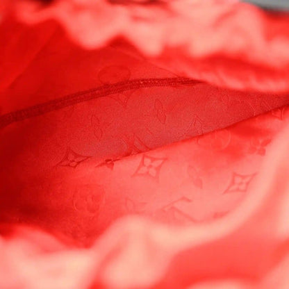 Red monogram-lined interior fabric detail, zip edge close-up