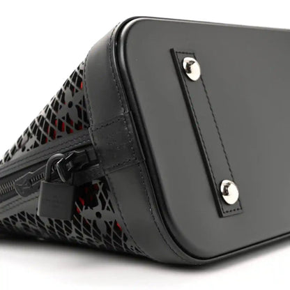 Black leather handbag with monogram cutout side and silver hardware studs