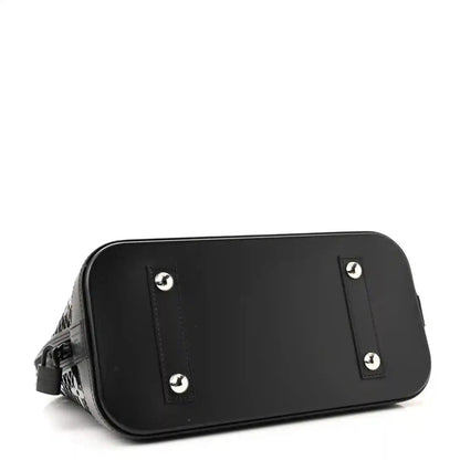 Black patent Alma PM handbag back base with four metal stud accents