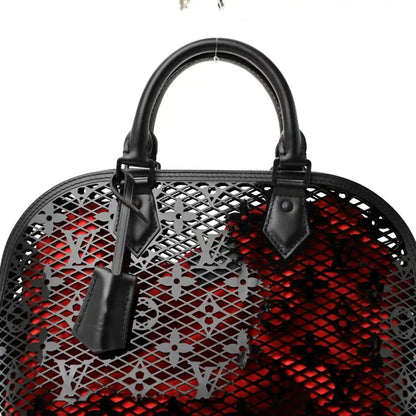 Front view of black lattice monogram handbag with red interior and handles