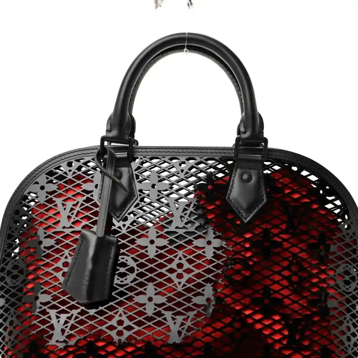 Front view of black lattice monogram handbag with red interior and handles