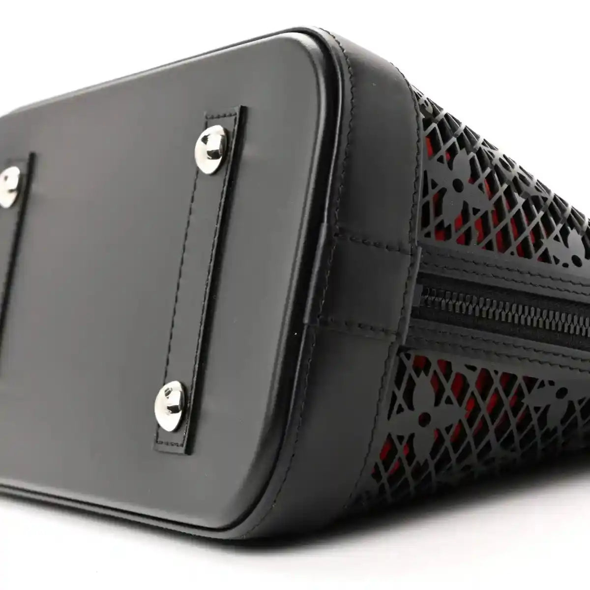 Black patent leather handbag with silver snap hardware and monogram laced side trim