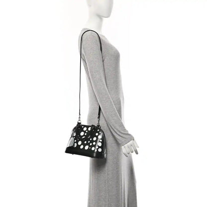 Alma BB bag with white polka dots, small top zipper, long crossbody strap and charm