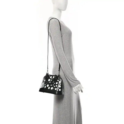 Alma BB bag with white polka dots, small top zipper, long crossbody strap and charm