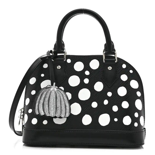 Alma BB bag with black leather look, white polka dots, top handles, pumpkin charm