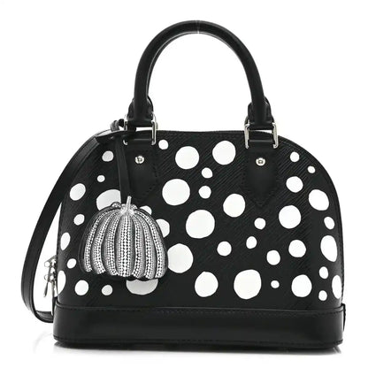 Alma BB bag with black leather look, white polka dots, top handles, pumpkin charm