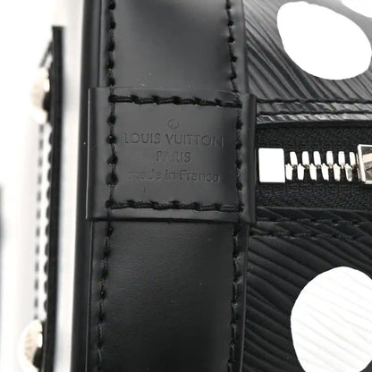 Alma BB bag leather tag with “Louis Vuitton Paris Franco” text and stitched seam