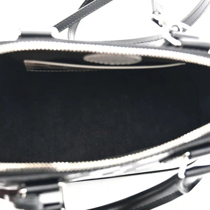 Alma BB bag zipper close-up with metal teeth and black leather trim over interior lining