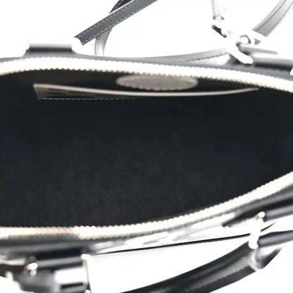 Alma BB bag zipper close-up with metal teeth and black leather trim over interior lining
