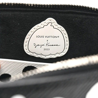 Alma BB bag charm label reading “Louis Vuitton x Yayoi Kusama 2023” on stitched oval