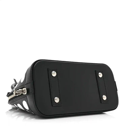 Alma BB bag with smooth black front panel, silver stud hardware, zipper pocket detail