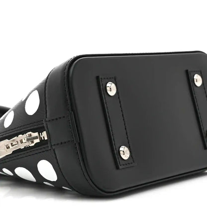 Alma BB bag side with smooth black panel, silver studs, and zipper hardware
