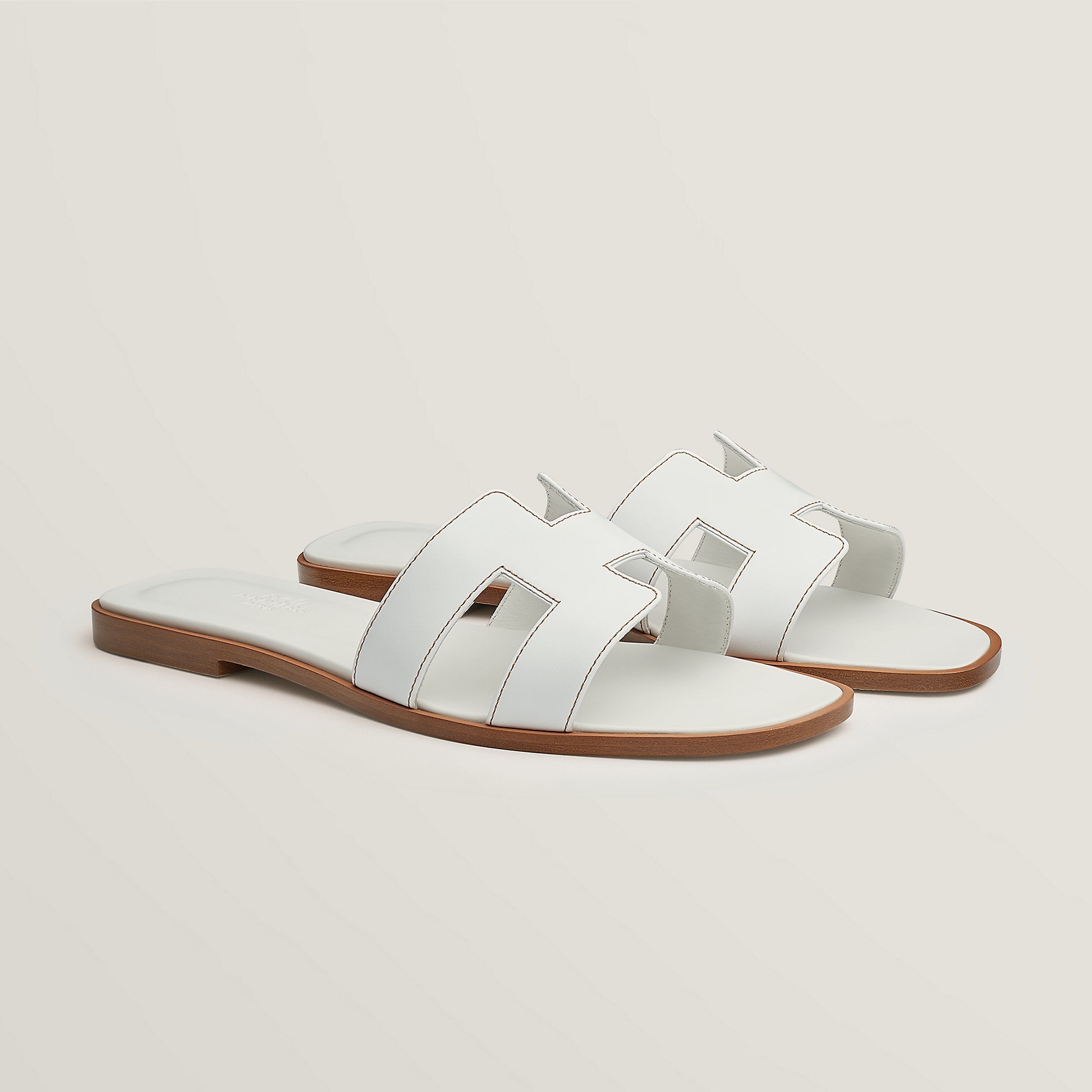 Hermès Oran slide sandal, white leather, open square toe, flat brown sole