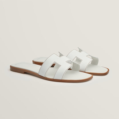Hermès Oran slide sandal, white leather, open square toe, flat brown sole
