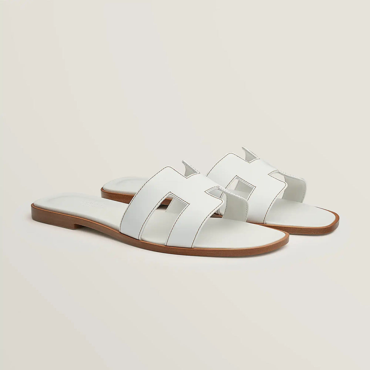 Hermès Oran slide sandal, white leather, open square toe, flat brown sole