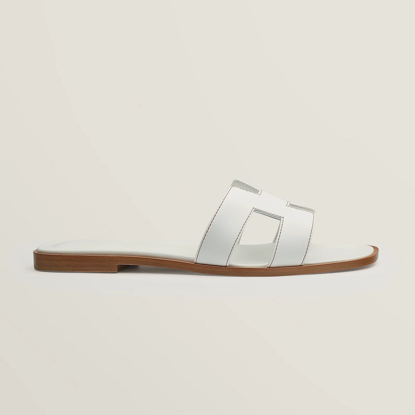 White leather slide sandal with two wide straps and stitched H-style cutouts