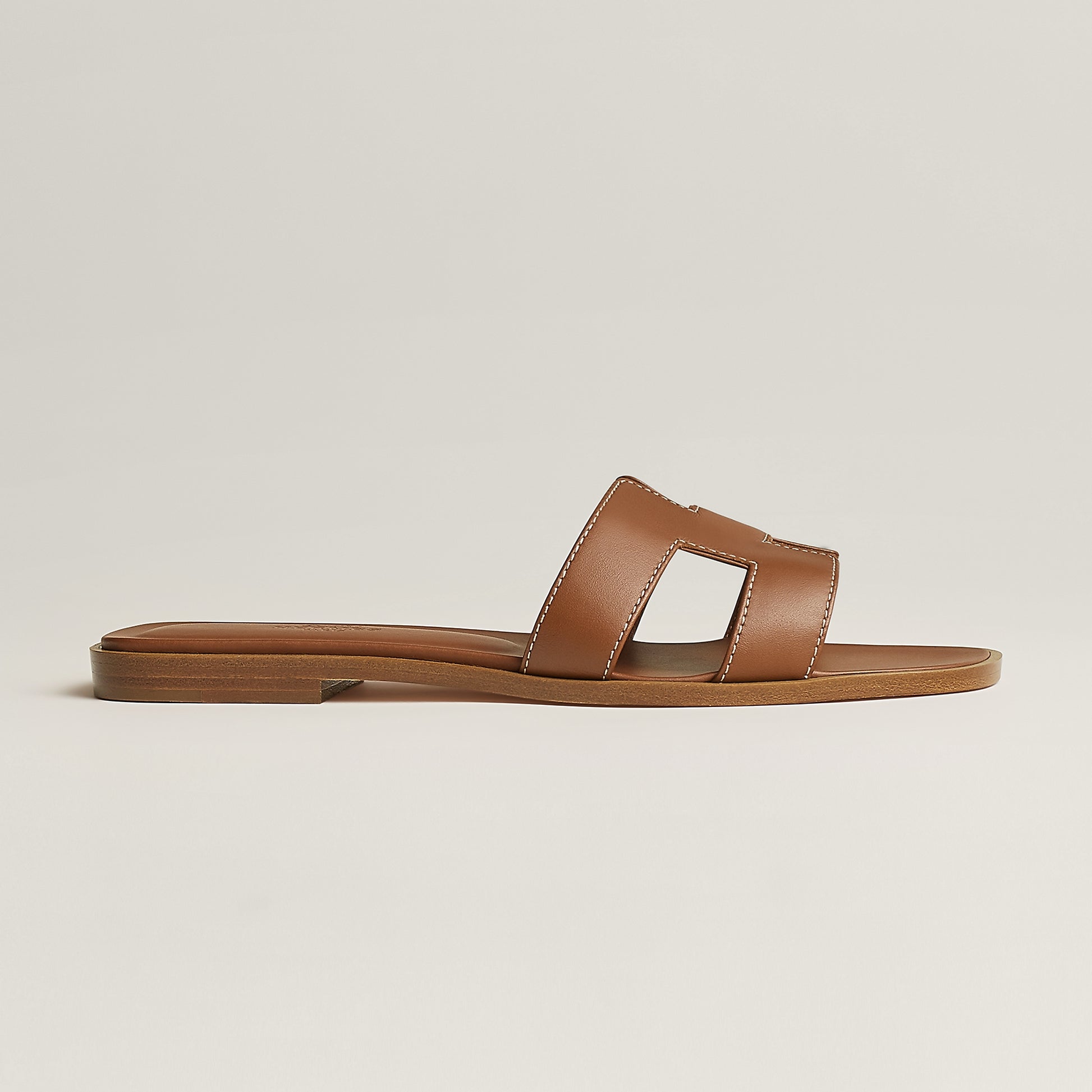 Hermès Oran slide sandal, tan leather, open square toe, flat brown sole