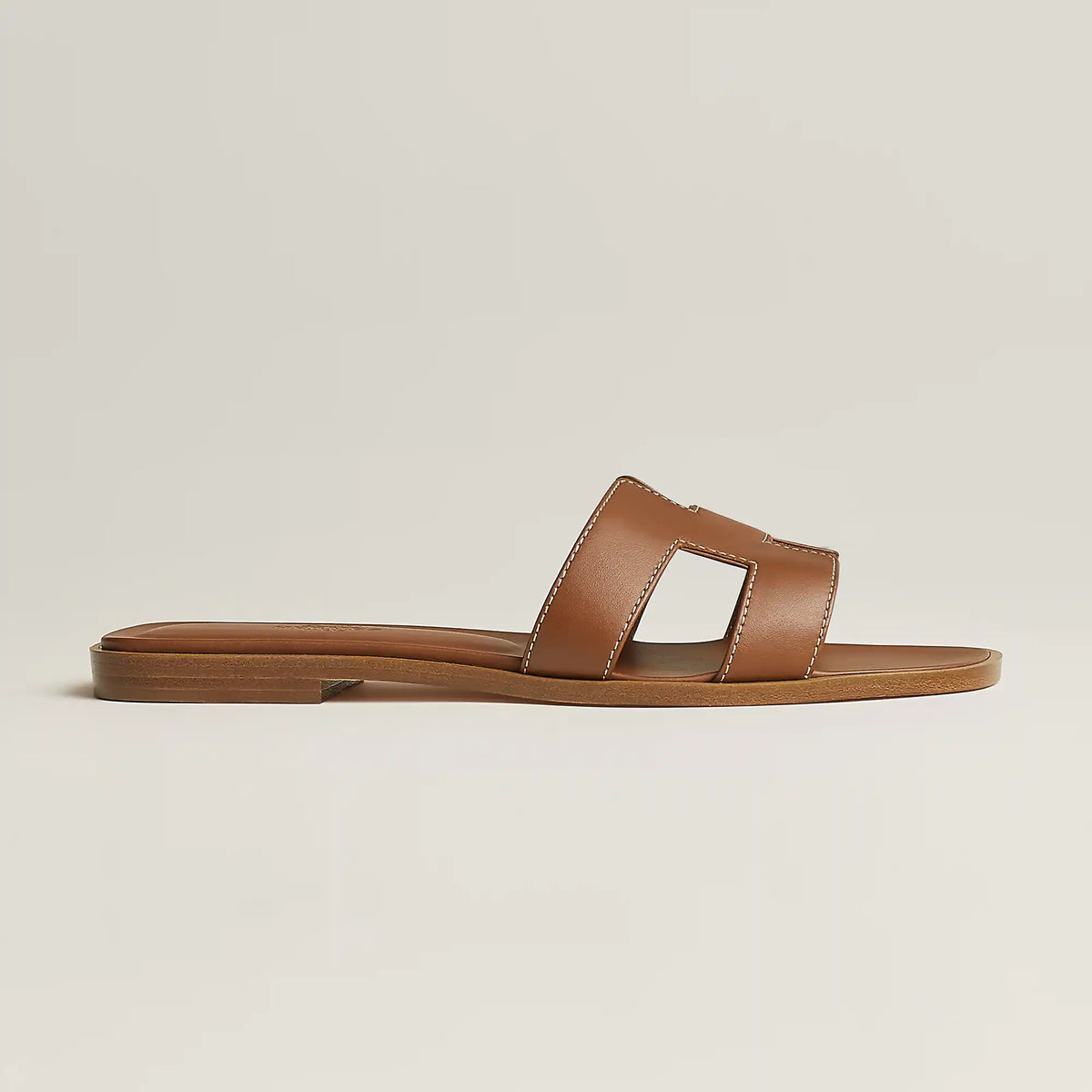 Hermès Oran slide sandal, tan leather, open square toe, flat brown sole